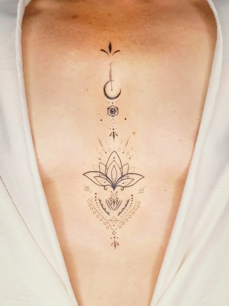 Fineline Tattoo Lotus Blume Brust Dekolte Tattoo