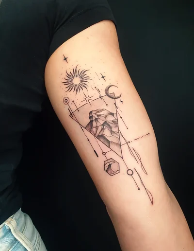 Realistic Tattoo eines Bergmotivs mit Sonne, Mond, geometrischen und Fineline-Elementen auf dem Oberarm.