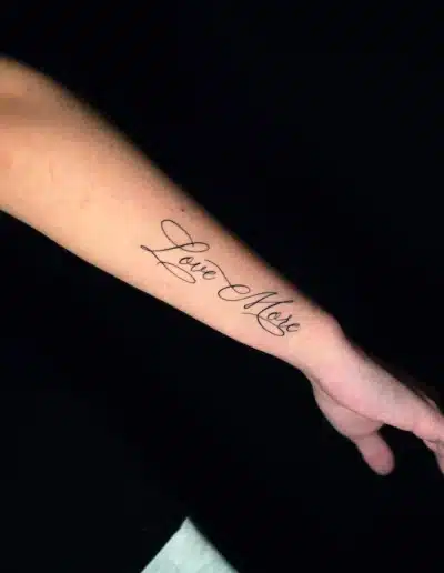 Love More Schriftzug Tattoo am Unterarm bei EB-Tattoo St. Gallen